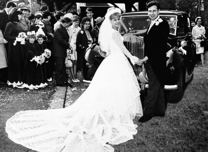 A large family and community gathered together in a nostalgic vintage wedding photograph