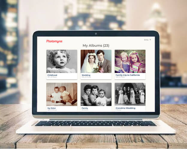 A family photo collection organized into albums on a laptop